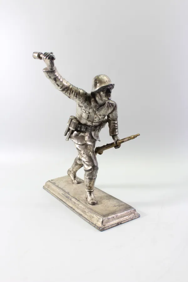 Plastische Darstellung eines mit Handgranate Voranstürmenden Infanteristen. Spritzguss versilbert, Gesamthöhe 23,5cm