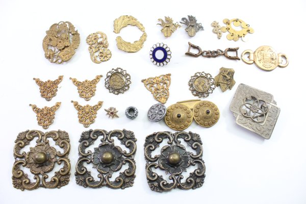 Discover a unique collection of 27 original uniform parts, buttons, badges, overlays, and buckles
