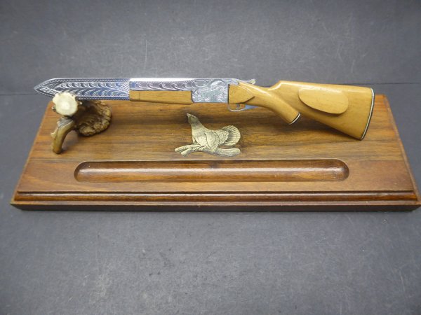 Gun shaped letter opener with stand